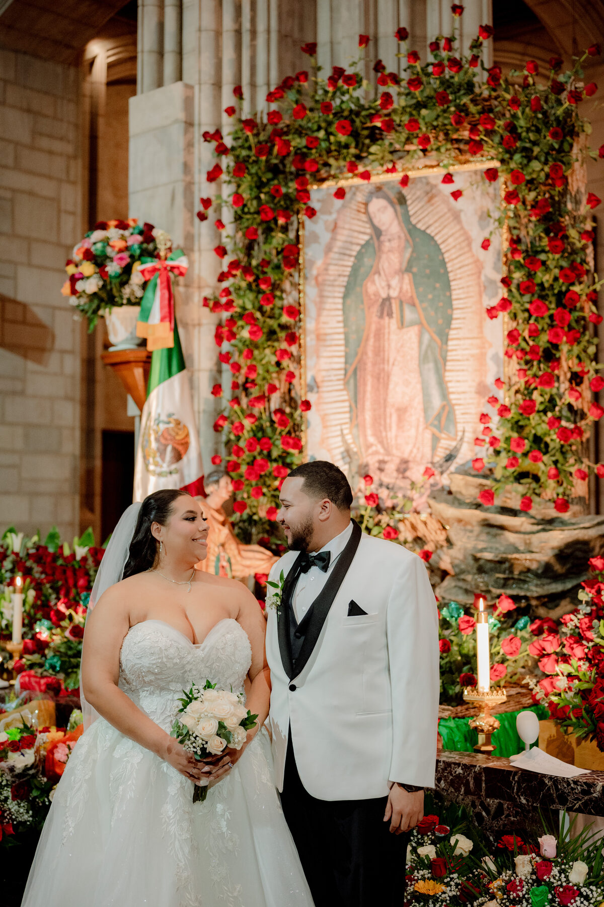 Couple kiss at floral backdrop